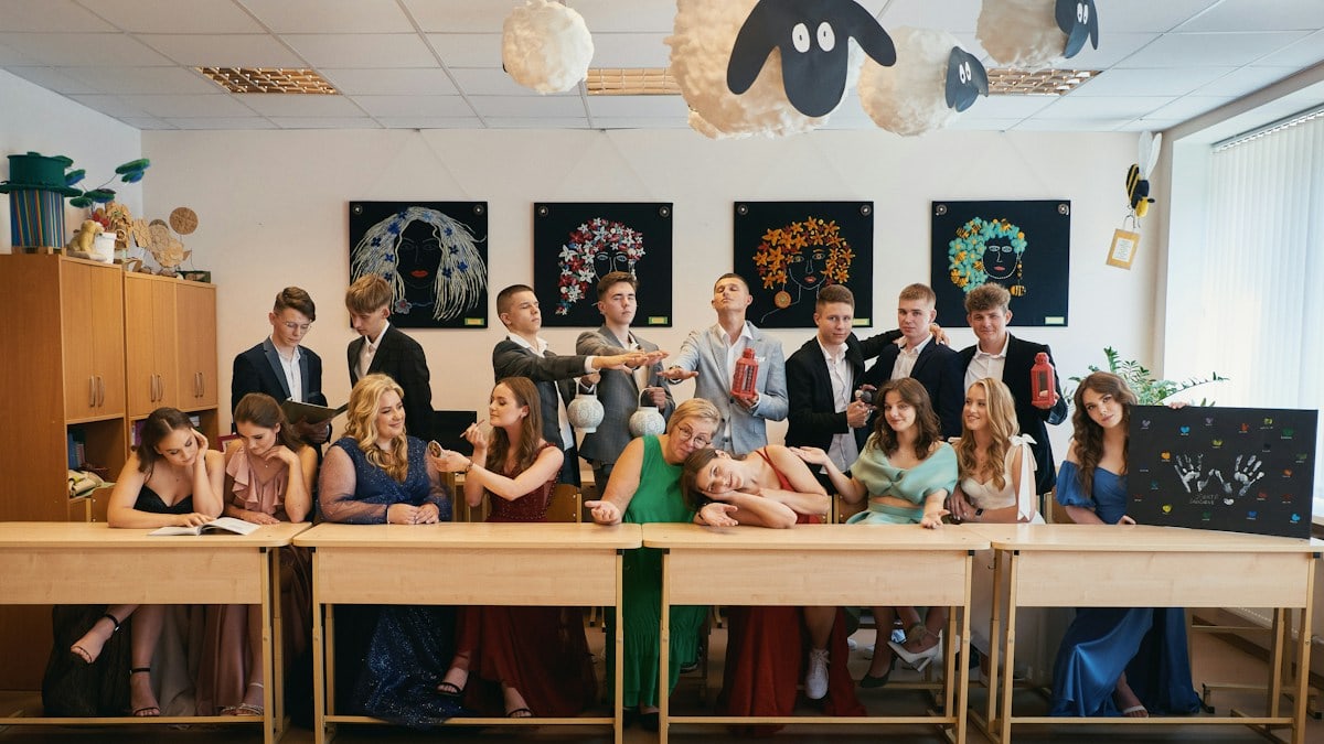 a group of people sitting at a long table